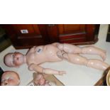 A Victorian porcelain headed A M doll with composition body (missing wig)