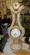 A beautiful French ormolu mounted white marble lyre clock with swinging paste set bezel by Gille l'