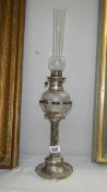 A silver plated oil lamp designed by Christopher Dresser,