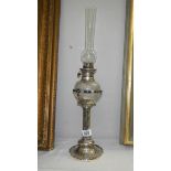 A silver plated oil lamp designed by Christopher Dresser,