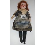 A Victorian porcelain doll in original dress