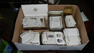 Approximately 600 Ogden's cigarette cards and an Oxo tin.