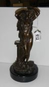 A hollow bronze semi nude female figure on marble base