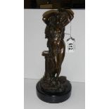 A hollow bronze semi nude female figure on marble base