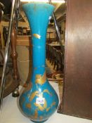 A tall 19th century Japanese ovoid turquoise coloured vase decorated with gold birds and flora