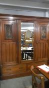 A mahogany triple door wardrobe