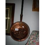 A Victorian copper warming pan