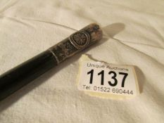 A silver tipped swagger stick with St.