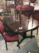 An oval mahogany dining table