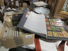 A box of miscellaneous collectables including old postcards,