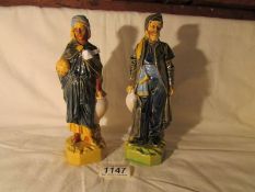 A pair of ceramic figures of Arabian merchants