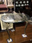 A glass top coffee table with metal base