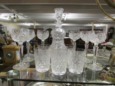 A cut glass decanter and 12 glasses
