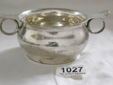 A two handled silver cup in the style of a Scottish Quaich, Sheffield hall mark, maker S & W,