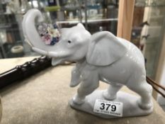 A Lladro elephant (tusk repaired)