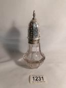 A glass sugar sifter with silver top hall marked Sheffield 1922/23