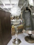 A silver plate oil lamp with glass font and etched shade