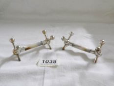 A pair of silver and mother of pearl knife rests, hall marked Sheffield 1916,