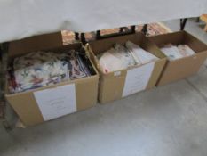 2 boxes of assorted table linen and a box of scarves etc