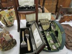 A quantity of cased cutlery sets