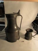 A pewter ale jug and a small pewter jug