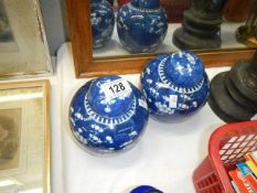 A pair of oriental ginger jars with covers