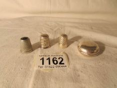 A silver sovereign case, a silver thimble,