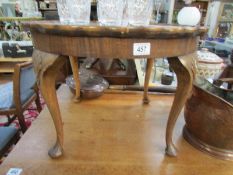 A circular coffee table on Queen Anne style legs