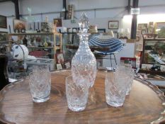 A cut glass decanter and 6 glasses