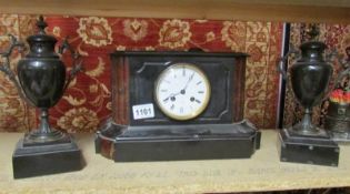 A Victorian black marble clock garniture