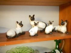 4 Beswick Siamese cats and a Royal Doulton example