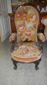 A mahogany framed chair with tapestry seat and back