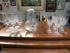 A water carafe and 12 glasses