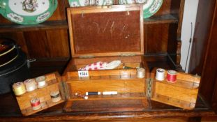 An Edwardian oak sewing box with contents