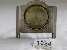 A small dressing table clock in silver frame (clock needs attention)