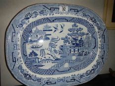 A blue and white willow pattern meat platter