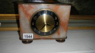 An art deco brass and onyx mantel clock