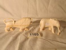 A 19th century carved ivory lion and elephant