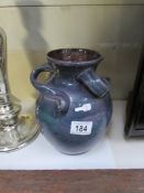 A 3 handled glazed vase by Baron pottery,