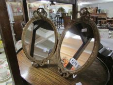 A pair of oval gilt framed Adam's style mirrors