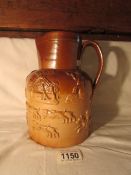 A 19th century stoneware jug with hunting scenes