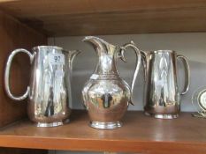 A silver plated chocolate pot and a pair of silver plated hot water jugs