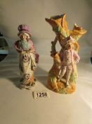 A 19th century German bisque figural vase and a 19th century German glazed figurine