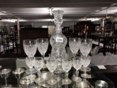 A cut glass decanter and 10 glasses