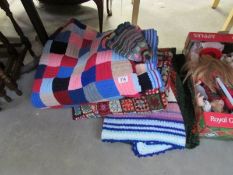 A quantity of knitted and crocheted blankets