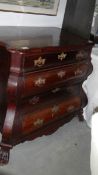 A mahogany bombe chest of 4 drawers