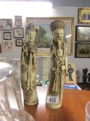 A pair of early 20th century Chinese ivorene 'Carved tusk' composition figurines being a robed