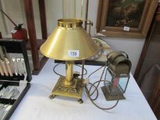 A brass table lamp and a lantern style candle lamp