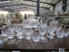 A cut glass jug and a quantity of glasses