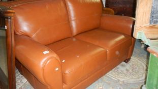 A pair of tan leather 2 seat sofa's